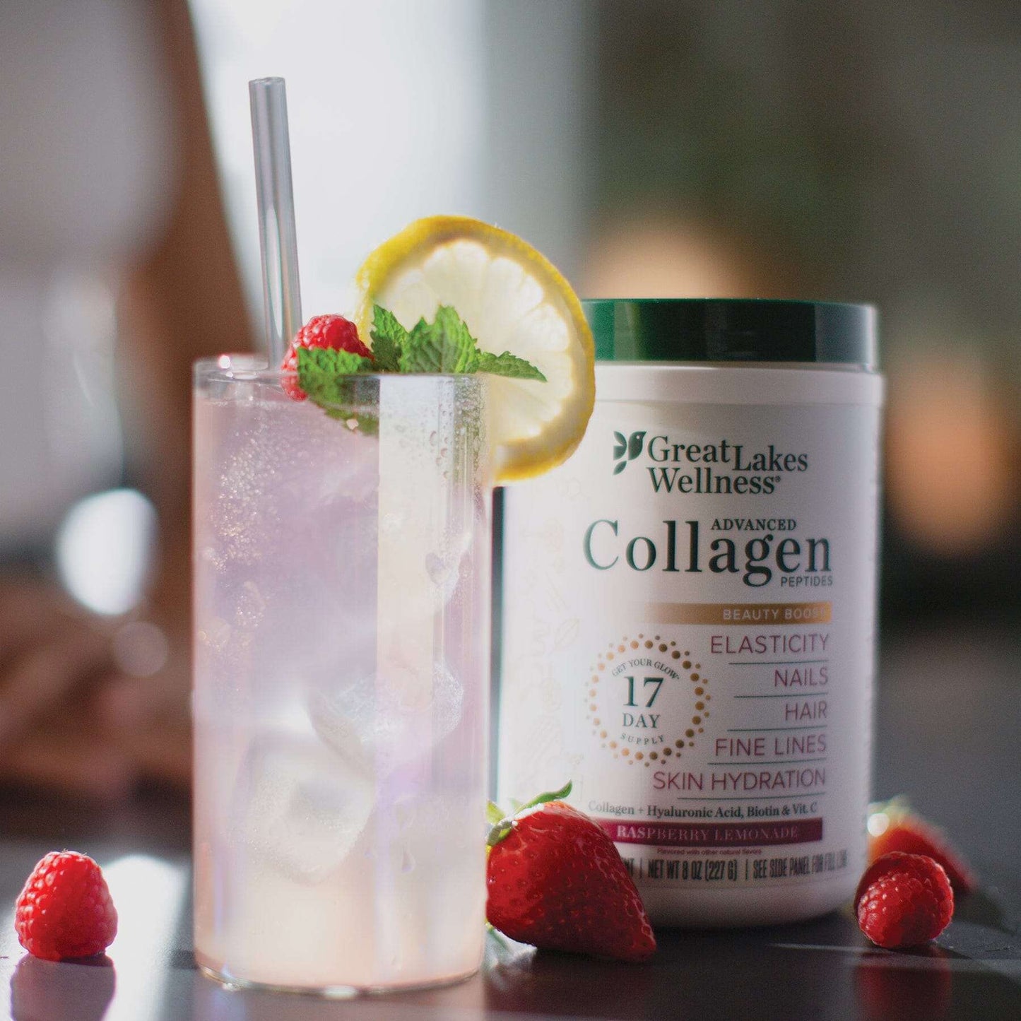 Beauty Boost Advanced Collagen Peptides Raspberry Lemonade with bottle and garnished glass.