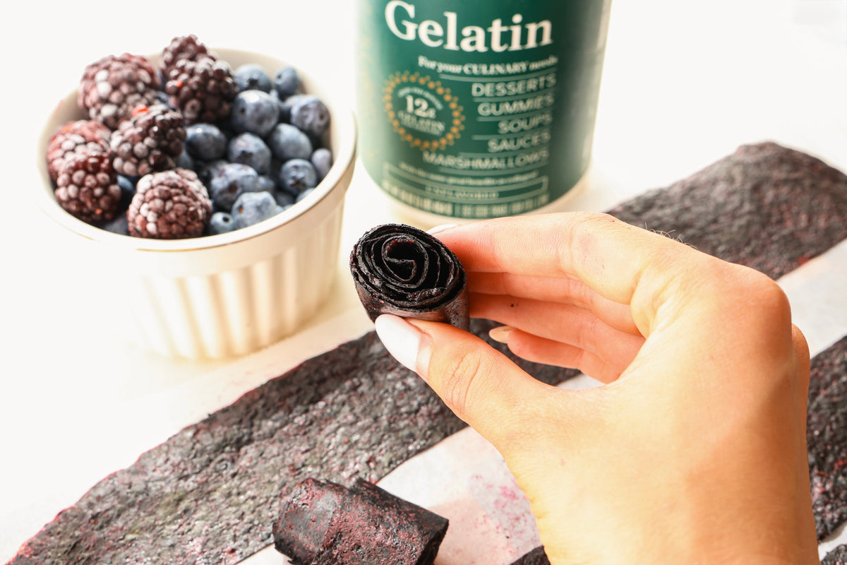 Rolled blueberry blackberry fruit leather with fresh berries and Great Lakes Wellness Beef Gelatin.
