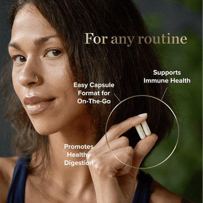 Woman holding two Colostrum Capsules promoting immune health and digestion support in easy on-the-go format