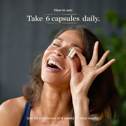 Woman holding creatine capsules promoting daily intake for muscle growth and strength support